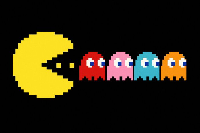 Pac Man eating a row of ghosts like companies buying up companies.